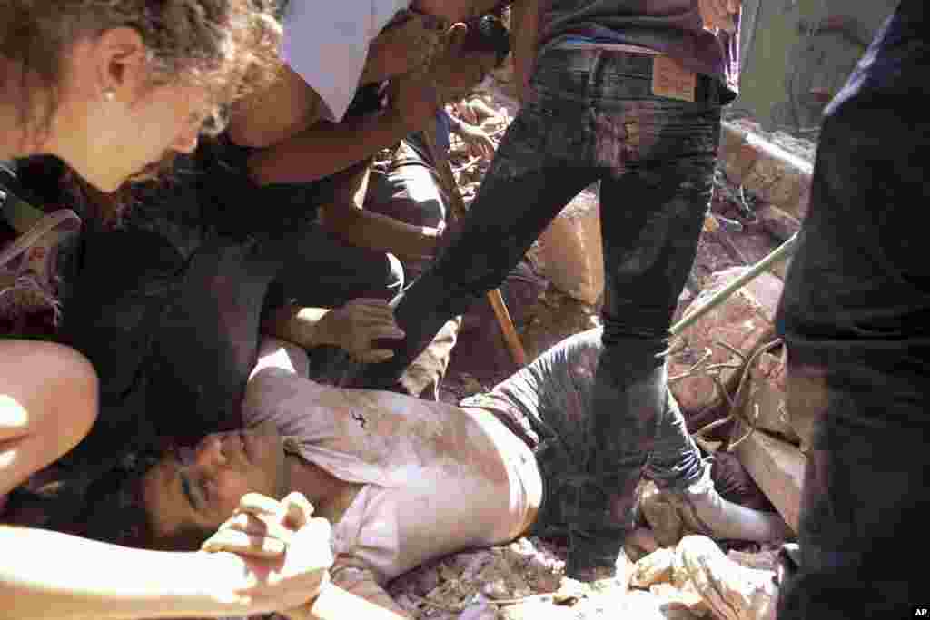 A man is rescued from a collapsed building in the Condesa neighborhood of Mexico City after an earthquake, Sept. 19, 2017.