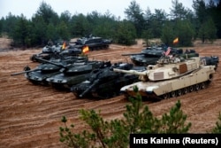 Latvia October - U.S., German, Spanish and Polish troops of the NATO enhanced Forward Presence battle goups with their tanks get ready for the Iron Tomahawk exercise in Adazi
