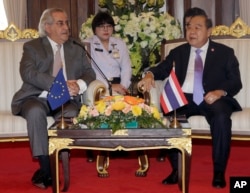 FILE - European Union delegation chief Cesar Deben, left, meets Thai Deputy Prime Minister and Defense Minister Prawit Wongsuwan in Bangkok, Thailand, Jan. 22, 2016. The EU is maintaining the threat of a seafood import ban on Thailand.