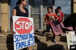 People participate in a protest against recent U.S. immigration policy that separates children from their families when they enter the United States as undocumented immigrants, in front of a Homeland Security facility in Elizabeth, New Jersey, June 17, 20