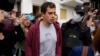 FILE - Police officers and journalists surround Roman Dobrokhotov in Moscow, July 28, 2021.
