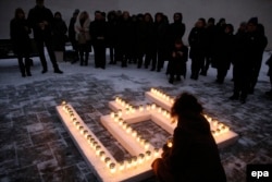 Lithuania -- Commemorating the victims of the Soviet aggression of 13 January 1991, people place lit candles in the shape of the Columns of Gediminas outside the Ministry of Education and Science in Vilnius, January 12, 2017