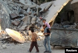 Syria -- Children walk along a damaged street filled with debris in the Damascus suburb of Zamalka, October 3, 2013