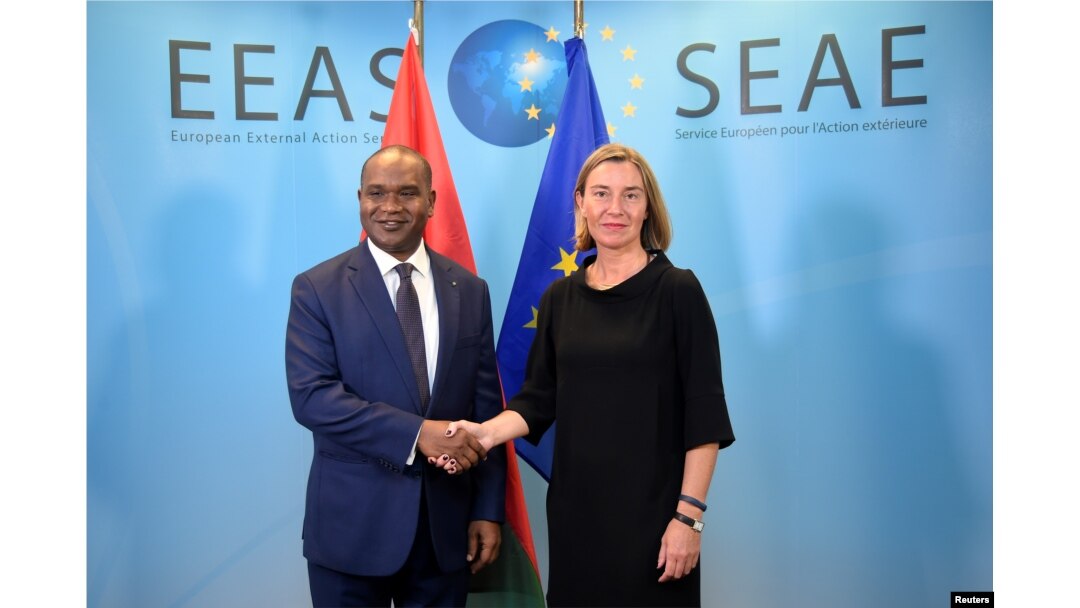 FILE - EU foreign policy chief Federica Mogherini welcomes Burkina Faso Foreign Minister Alpha Barry, left, before a G-5 Sahel Ministerial meeting at EU headquarters in Brussels, Belgium, June 18, 2018.