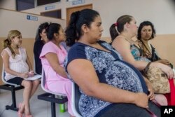 In this Jan. 29, 2016 photo, women wait their turn for their pre-natal exams at the National Hospital for Women in San Salvador, El Salvador.