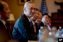 Chinese Vice Premier Liu He, center, accompanied by other Chinese officials, begins talks with U.S. Trade Representative Robert Lighthizer at the Executive Office Building, Jan. 30, 2019.