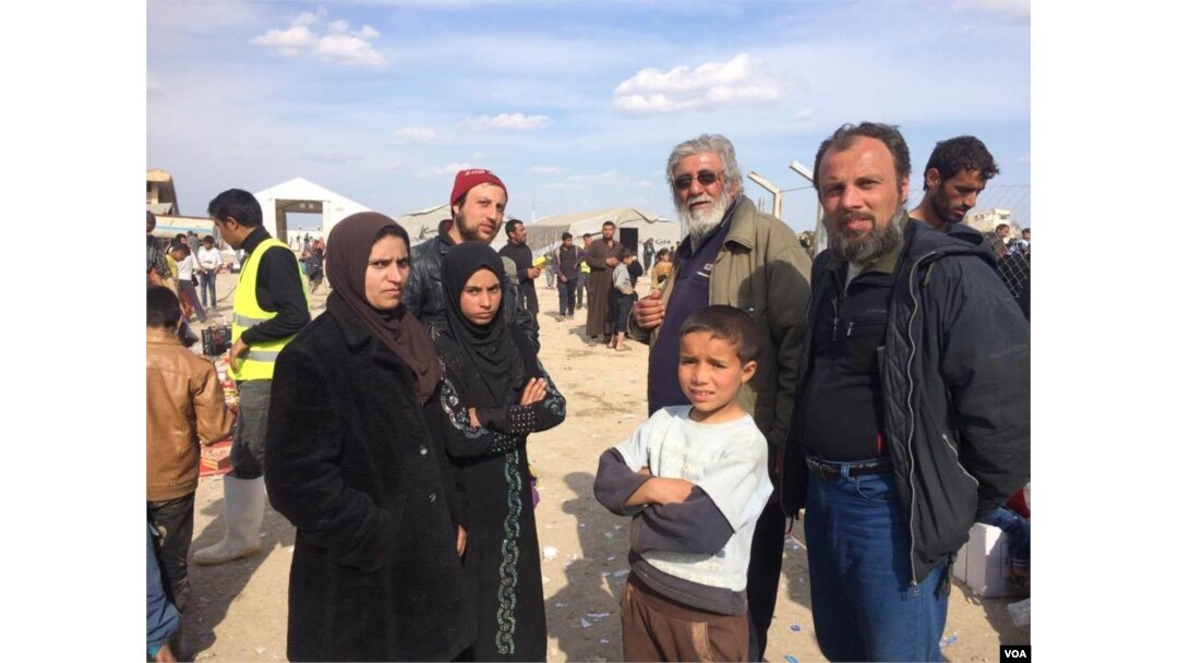 The family of Ammar Hazzin (3rd from L) says their flight from New Mosul was delayed after 21 people were executed by IS militants for attempting escape on March 26, 2017 in Hammam Alil, Iraq. (H.Murdock/VOA)