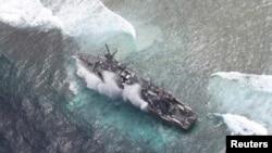 FILE - The USS Guardian, a U.S. Navy minesweeper, is seen at the Vicinity of South Islet in Tubbataha Reefs after it ran aground in Palawan province, west of Manila January 19, 2013 in this handout picture distributed by the Armed Forces of the Philippine