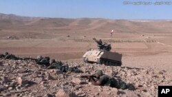 In this photo released on Aug. 23, 2017, by the Lebanese Army official website, Lebanese soldiers take position during a battle against Islamic State militants, on the outskirts of Ras Baalbek, northeast Lebanon.
