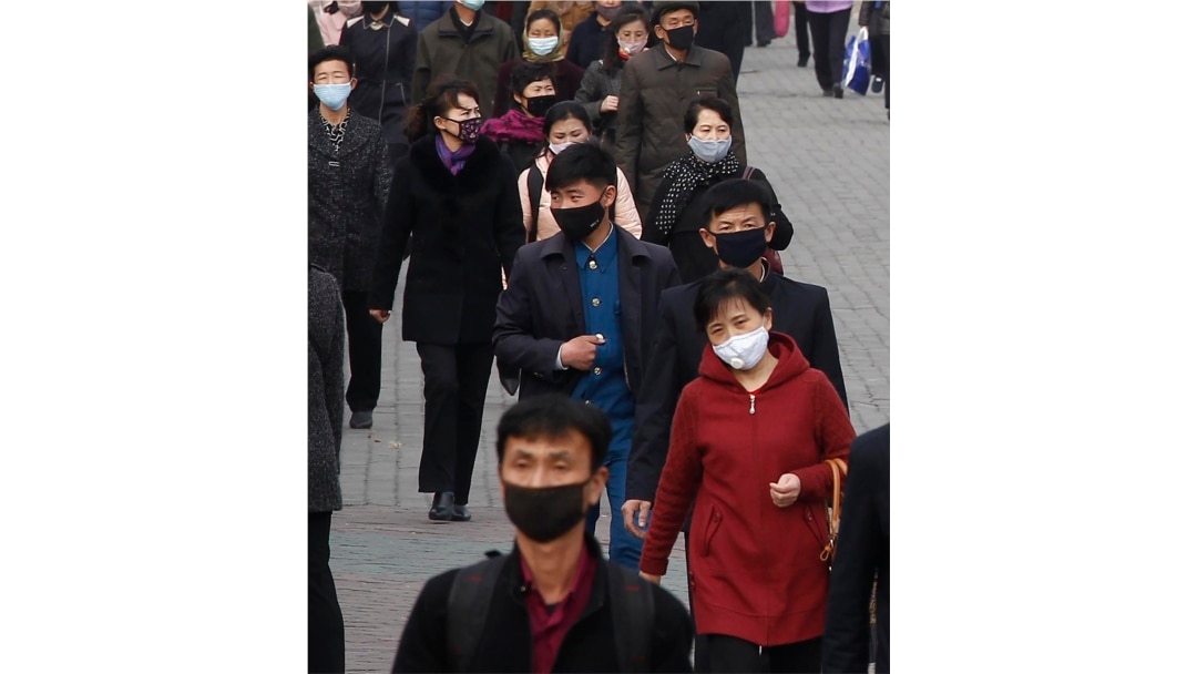 FILE - People wear face masks amid the concern over the spread of the coronavirus in Pyongyang, North Korea, April, 1, 2020.