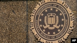 FILE - The seal on the J. Edgar Hoover FBI Building is seen in Washington. A man who worked for the U.S. government has been charged with leaking classified information assessing Israel's earlier plans to attack Iran, according to court papers filed on Nov. 13, 2024. 