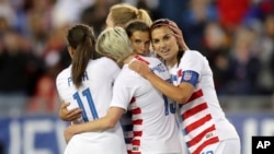 FILE - United States' Tobin Heath, second from right, is congratulated on her goal by Mallory Pugh (11), Megan Rapinoe and Alex Morgan (13) in 2019. (AP Photo/Mike Carlson)