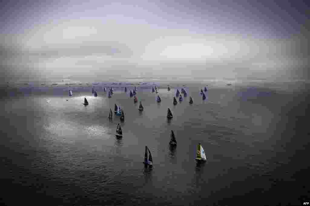 Skippers sail their Imoca 60 monohulls at the start the 10th edition of the Vendee Globe around the world monohull solo sailing race, off Les Sables-d'Olonne, France.