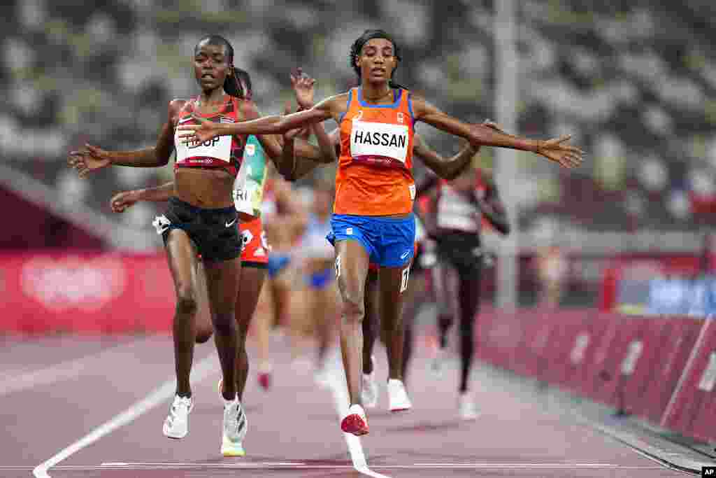 Sifan Hassan, of the Netherlands, right, crosses the finish line ahead of Agnes Jebet Tirop, of Kenya, left, to win a heat in the women's 5,000-meter run at the 2020 Summer Olympics, Friday, July 30, 2021, in Tokyo. (AP Photo/Petr David Josek)