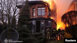 Firefighters work at the site of a Russian missile strike in Dnipro, Ukraine, Nov. 21, 2024. (Press service of the State Emergency Service of Ukraine in Dnipropetrovsk region via Reuters)