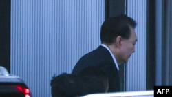 Impeached South Korean President Yoon Suk Yeol arrives at the Corruption Investigation Office for High-ranking Officials in Gwacheon, South Korea, Jan. 15, 2025.