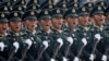FILE - Soldiers of People's Liberation Army march in formation during the military parade marking the 70th founding anniversary of People's Republic of China, on its National Day in Beijing, Oct. 1, 2019.