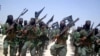 FILE - Al-Shabab fighters march with their weapons during exercises on the outskirts of Mogadishu, Somalia, Feb. 17, 2011. 