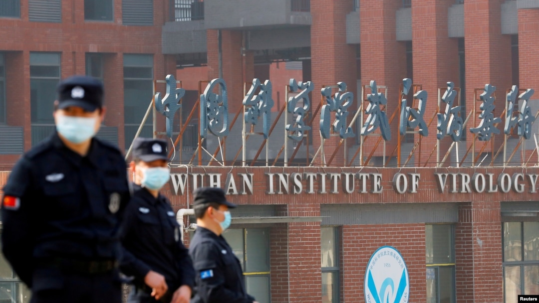 FILE - Security personnel keep watch outside the Wuhan Institute of Virology during a visit by a World Health Organization team, in Wuhan, Hubei province, China, Feb. 3, 2021.