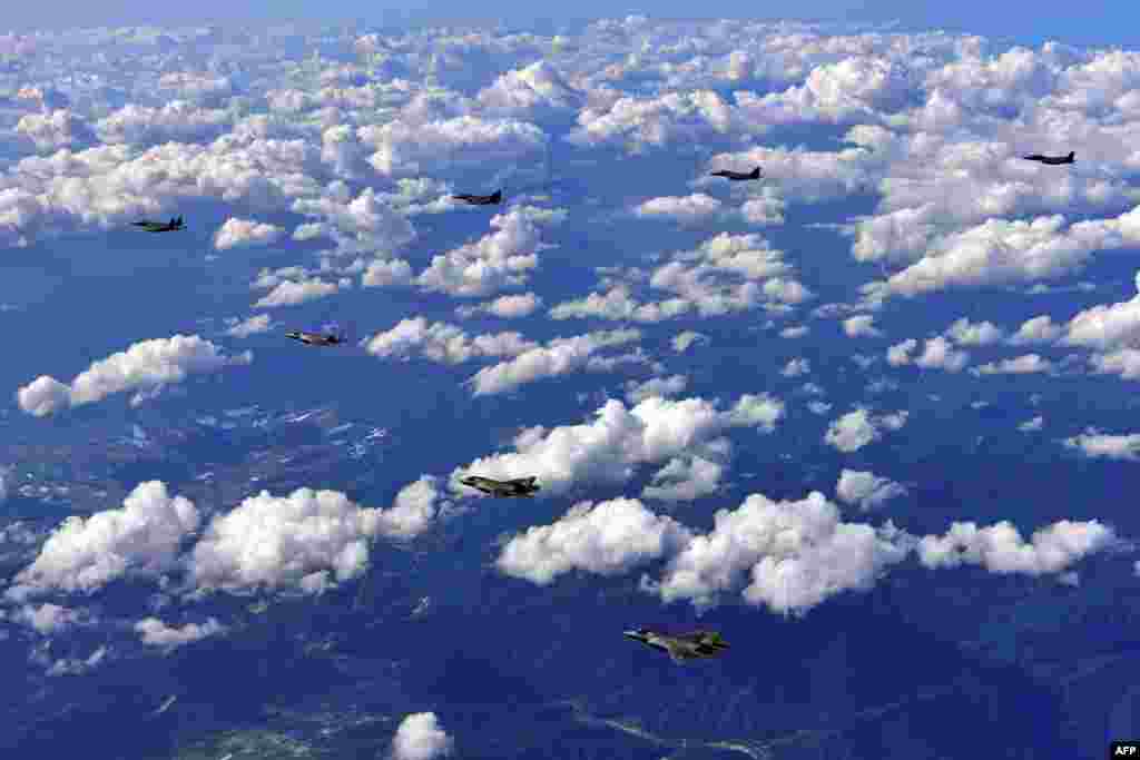 This handout photo provided by South Korean Defense Ministry in Seoul shows South Korean F-15K fighter jets and U.S. F-35B stealth jet fighters flying over South Korea during a joint military drill aimed at countering North Korea’s latest missile test.