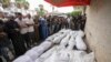 Mourners pray at the funeral for people killed in an Israeli strike, at Al-Aqsa Martyrs Hospital in Deir al-Balah, Gaza Strip, Aug. 17, 2024. The strike hit a house and adjacent warehouse sheltering displaced people at the entrance of the town of Zawaida, health officials said.
