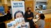 FILE - Marriott human resources recruiter Mariela Cuevas, left, talks to Lisbet Oliveros, during a job fair at Hard Rock Stadium, Sept. 3, 2021, in Miami Gardens, Florida.. 