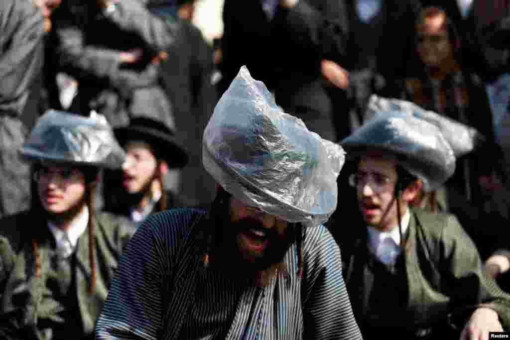 Israeli ultra-Orthodox Jewish men take part in a protest against the detention of a member of their community who refuses to serve in the Israeli army, in Jerusalem.