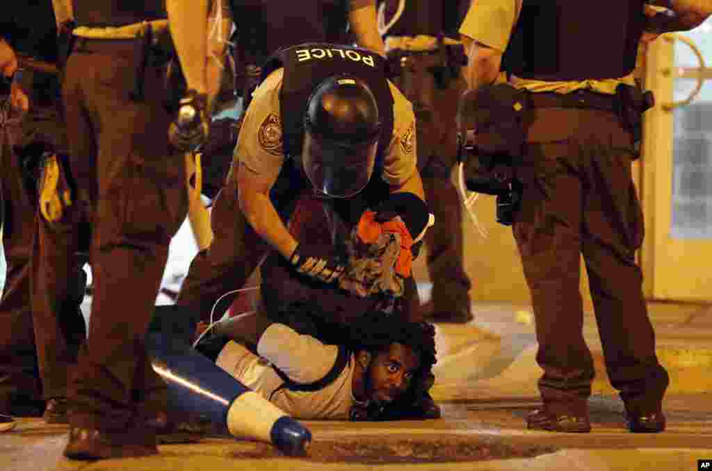 Police arrest a protester as demonstrators march in response to a not guilty verdict in the trial of former St. Louis police officer Jason Stockley, Sept. 17, 2017, in St. Louis, Missouri.