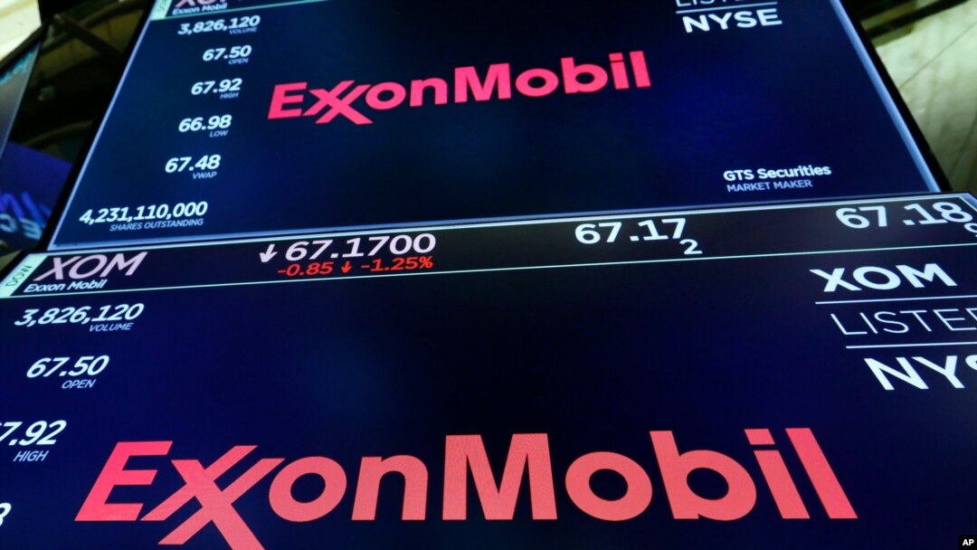 FILE - The logo for ExxonMobil appears above a trading post on the floor of the New York Stock Exchange, Oct. 8, 2019. 