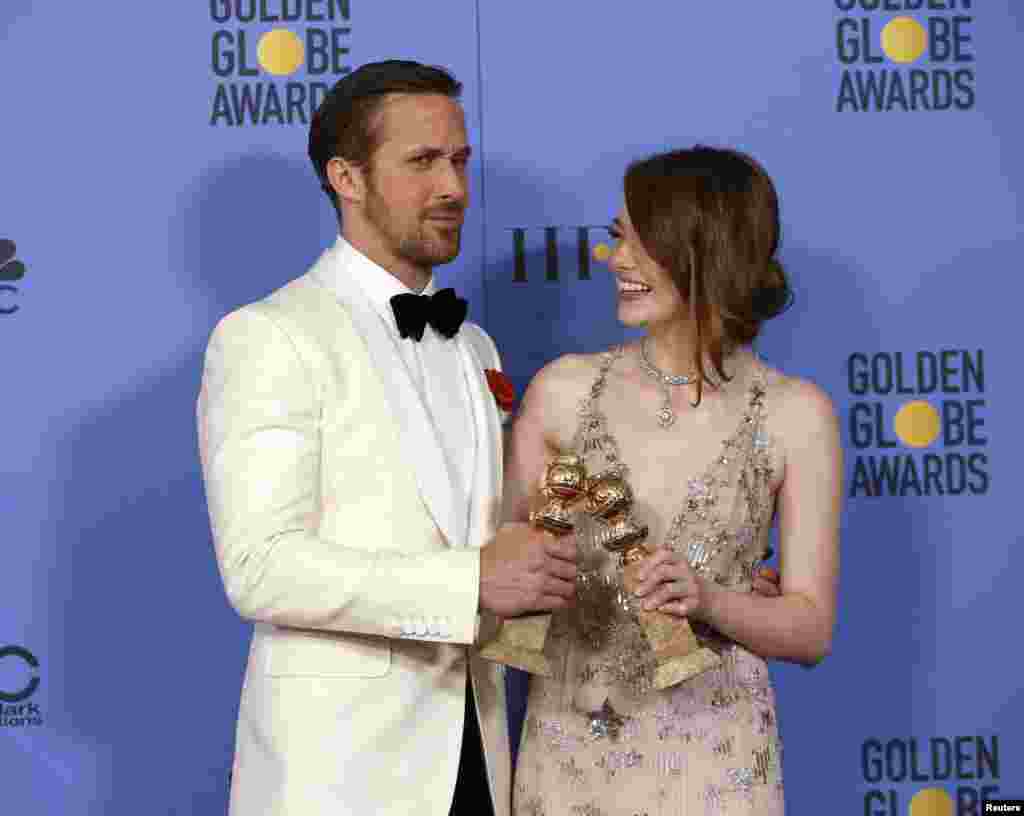 Ryan Gosling and Emma Stone pose with their awards for Best Performance by an Actor in a Motion Picture - Musical or Comedy and Best Performance by an Actress in a Motion Picture - Musical or Comedy for their roles in "La La Land" during the 74th Annual Golden Globe Awards in Beverly Hills, California, Jan. 8, 2017.
