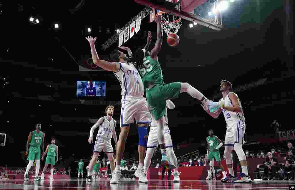 Nigeria's Precious Achiuwa (55) scores past Italy's Danilo Gallinari (8) during men's basketball preliminary round game at the 2020 Summer Olympics, Saturday, July 31, 2021, in Saitama, Japan. (AP Photo/Eric Gay)