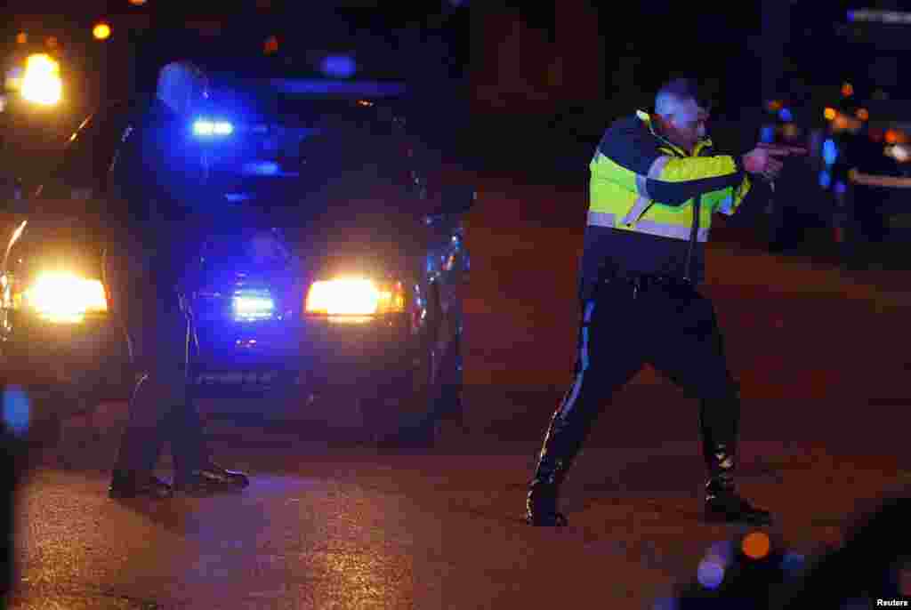 Police officers keep a man on the ground in Watertown, April 19, 2013 following the shooting of a police officer at the Massachusetts Institute of Technology (MIT).
