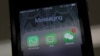 FILE - Icons of messaging applications WhatsApp of Facebook (L), Laiwang of Alibaba Group (C) and WeChat, or Weixin, of Tencent Group, are seen on the screen of a smart phone on this photo illustration taken in Beijing, February 24, 2014. 