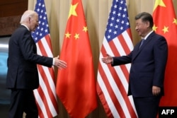 FILE - U.S. President Joe Biden shakes hands with Chinese President Xi Jinping on the sidelines of the Asia-Pacific Economic Cooperation summit in Lima, Peru, Nov. 16, 2024. (Pool/AFP)