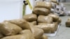 FILE - In this undated photo provided by the Australian Federal Police, packages containing methamphetamine are stacked in a warehouse in Melbourne, Australia.