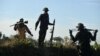 FILE - Members of the People's Defense Forces (PDF) who have taken up arms against Myanmar's military junta are seen on a front line in Kawkareik, Myanmar, Dec. 31, 2021.