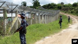 FILE - Myanmar border guards provide security near the fence at a no-man's land between Myanmar and Bangladesh, near Taungpyolatyar village, Maungdaw, northern Rakhine state, June 29, 2018. The Arakan Army claimed, Dec. 8, 2024, the capture of the last army outpost in Maungdaw.