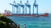 FILE - A vessel carries four cranes to be off-loaded at the port of Mombasa through the Kilindini channel, Kenya, on Aug. 7, 2023. Africa has seen significant growth in its port capacity in the past decade.