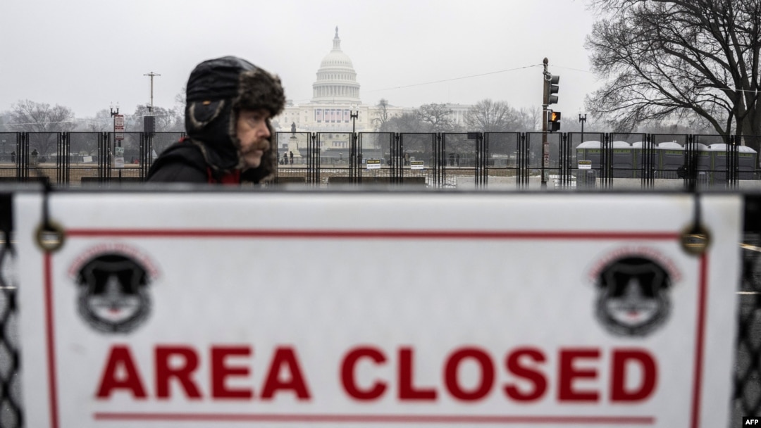 A supporter of US President-elect Donald Trump walks past a security barricade near the U.S. Capitol in Washington on Jan. 19, 2025, one day ahead of Trump's inauguration. 