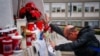 A man prays at the statue of John Paul II at the Gemelli hospital where Pope Francis is hospitalized with pneumonia, in Rome on March 1, 2025.