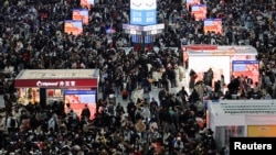 People wait for their trains during the Spring Festival travel rush ahead of the Lunar New Year, at Shanghai Hongqiao railway station in Shanghai, China, Jan. 24, 2025.