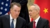 FILE - Chinese Vice Premier Liu He (R) talks with U.S. Trade Representative Robert Lighthizer, while they line up for a group photo at the Diaoyutai State Guesthouse in Beijing, Feb. 15, 2019. 
