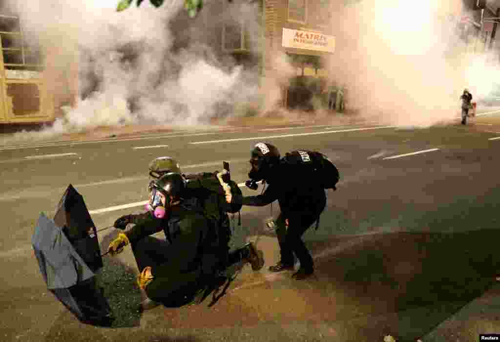 Demonstrators clash with Federal and Portland police at an Immigration and Customs Enforcement facility in Portland, Oregon.