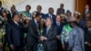 United Nations Secretary-General Antonio Guterres, center right, shakes the hand of Rwandan President Paul Kagame during the 28th Ordinary Session of the Assembly of the African Union, in Addis Ababa, Ethiopia, Jan. 30, 2017. 