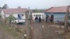 Police officials work at the scene of a mass shooting in Lusikisiki