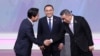 Lai Ching-te (L), presidential candidate from the Democratic Progressive Party, shakes hands with Ko Wen-je (R), presidential candidate from the Taiwan People’s Party, as Hou Yu-ih (C), presidential candidate from Kuomintang, looks on during a debate in Taipei in Dec. 2023. (AFP)