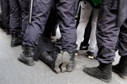 FILE - Police detain a gay rights activist during a rally marking May Day in downtown St. Petersburg, Russia, May 1, 2017.