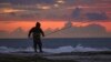 Tareq Aweid fishes at sunset near the border with Lebanon in Nahariya, Israel, Nov. 28, 2024. Aweid said he did not think the 60-day ceasefire between Hezbollah and Israel would last long. "No, no, the rockets will fall again."