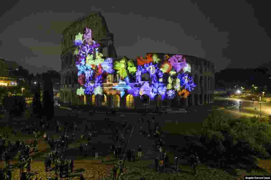 People watch the lighting ceremony at the Colosseum in Rome to mark the 150th anniversary of relations between Japan and Italy, 11 May 2016,