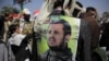 A Supporter of Houthi Shiites displays a poster of Abdel-Malek al-Houthi, the leader of Yemen's Shiite rebels, on his jacket during a rally to mark the third anniversary of the Houthis' takeover of the Yemeni capital, in Sanaa, Yemen, Sept. 21, 2017.